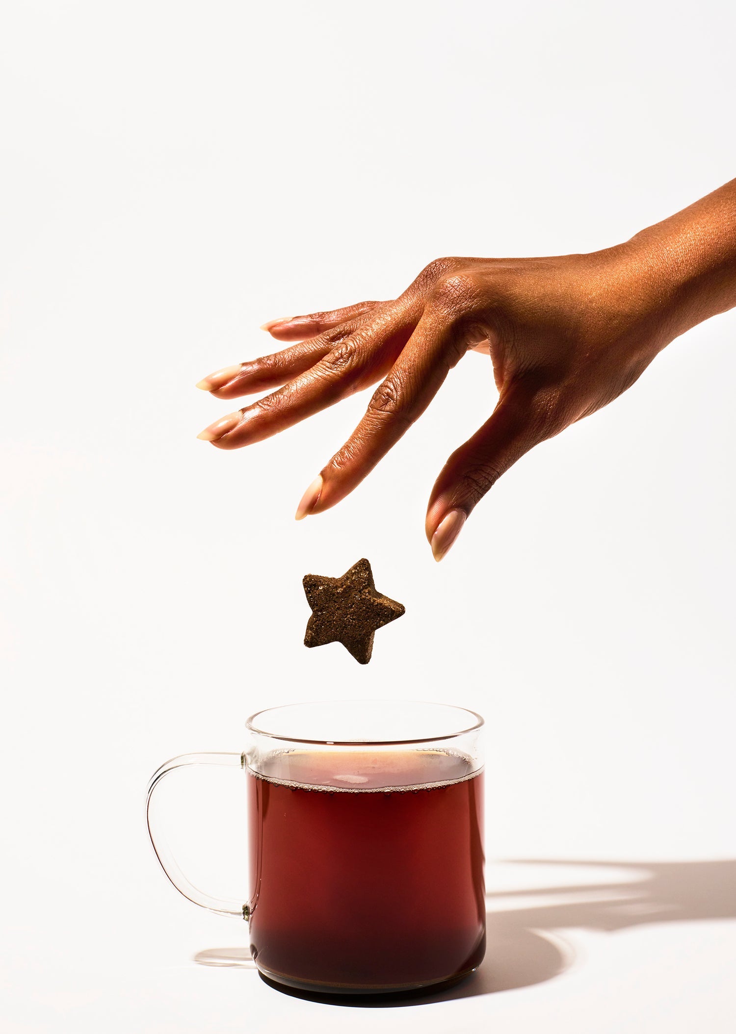 Tea Drop held above a cup of tea